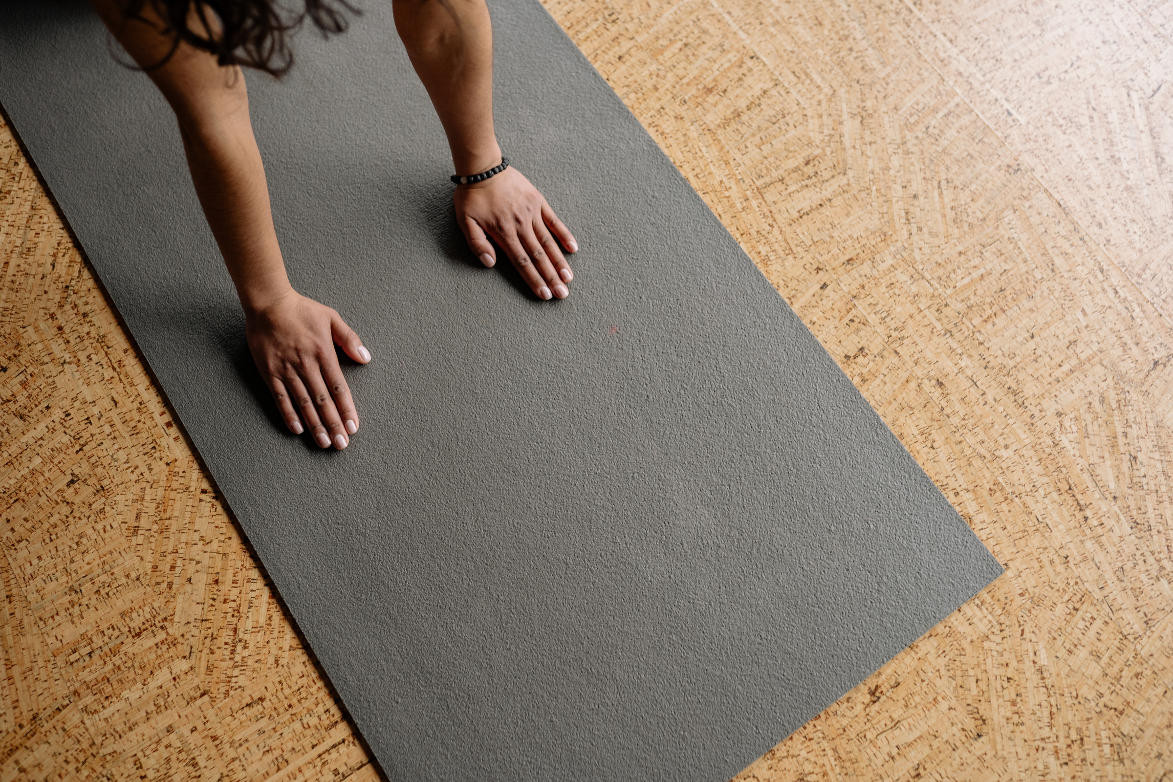 Hands of a Person on a Yoga Mat